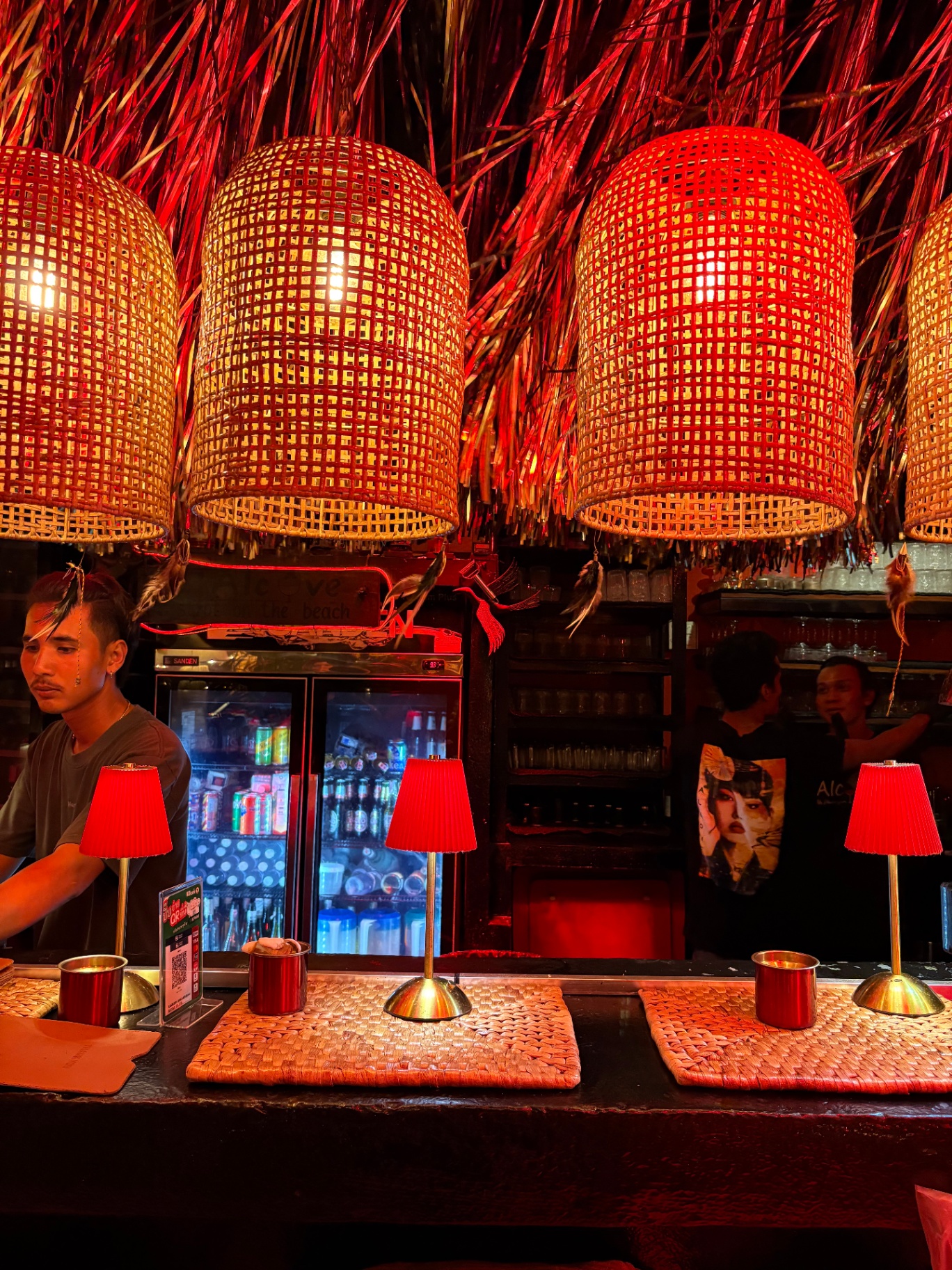 Bar under red rattan pendants